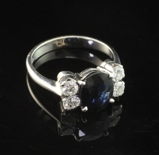 An 18ct white gold, sapphire and diamond ring, size L.